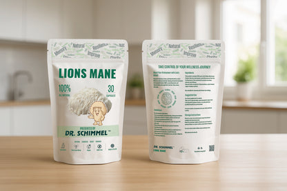 Two stand-up pouches of Dr. Schimmel Lions Mane supplement displayed on a wooden countertop with a blurred kitchen background.